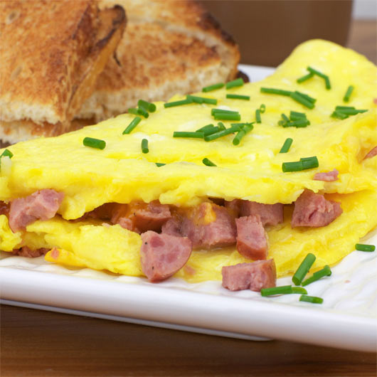 Summer Sausage Cheddar Omelette Garnished With Chives