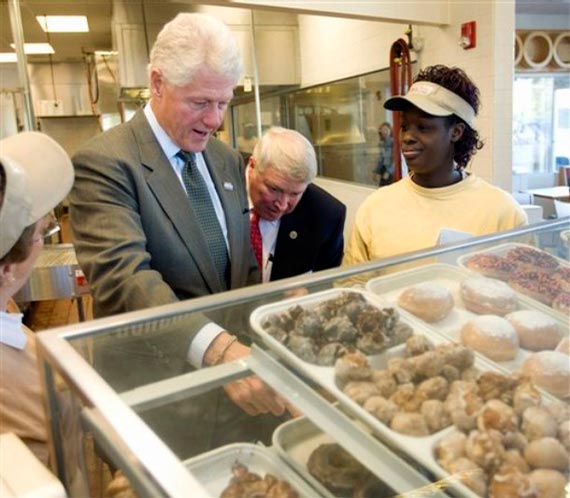 President Bill Clinton selects a doughnut