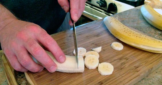 Slicing A Banana For Banana Cream Oatmeal