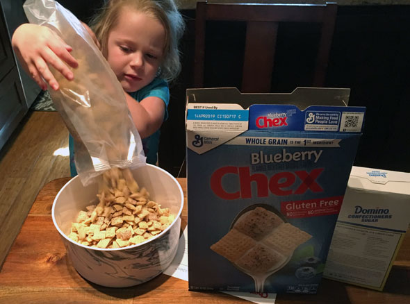Pouring Cereal To Make Muddy Buddies